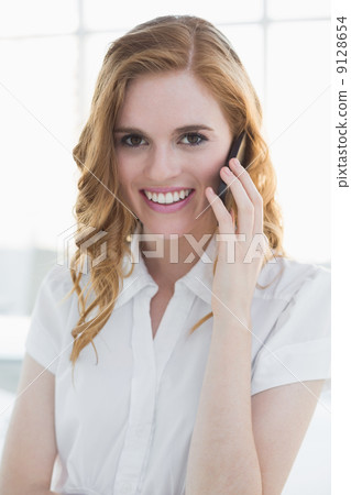 Elegant businesswoman using mobile phone in office Elegant businesswoman using mobile phone in office 9128654