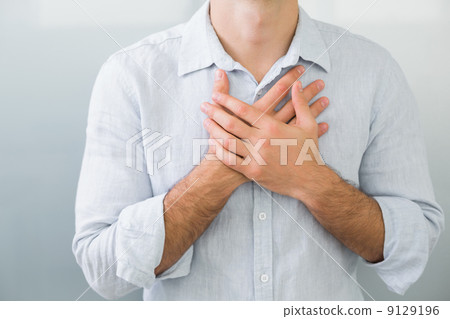 Mid section of a man with chest pain Mid section of a man with chest pain 9129196