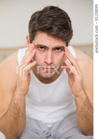 Close up of man suffering from headache in bed Close up of man suffering from headache in bed 9129899