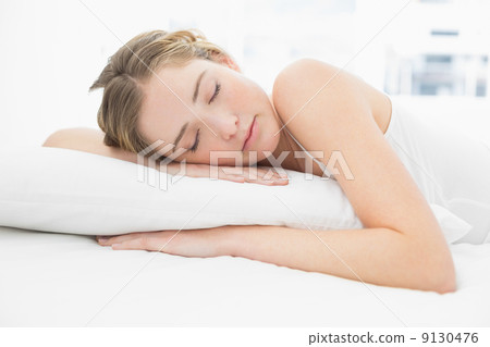 Pretty calm blonde lying in bed sleeping peacefully Pretty calm blonde lying in bed sleeping peacefully 9130476