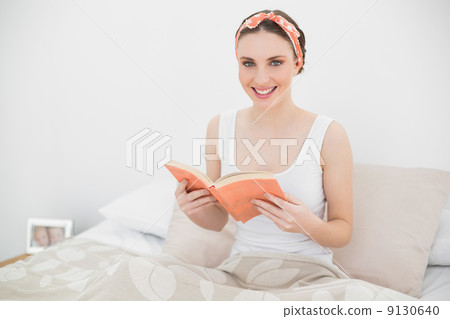 Smiling woman holding a book Smiling woman holding a book 9130640