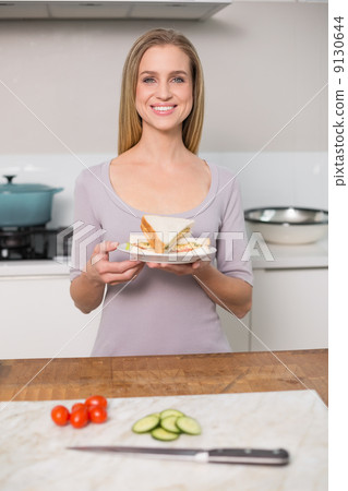 Smiling gorgeous model holding plate with sandwich Smiling gorgeous model holding plate with sandwich 9130644