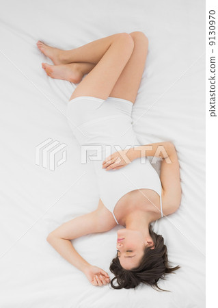 Beautiful young woman sleeping in bed Beautiful young woman sleeping in bed 9130970