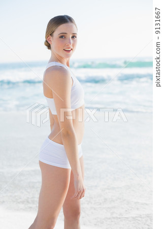 Attractive slender woman smiling at camera Attractive slender woman smiling at camera 9131667
