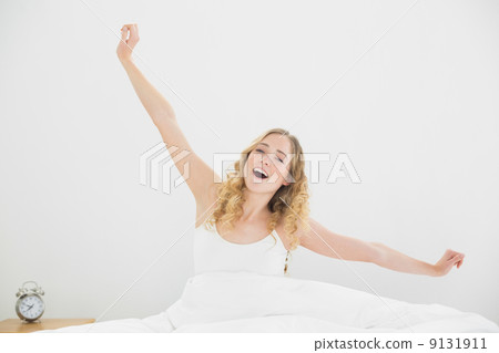 Pretty peaceful blonde sitting in bed yawning Pretty peaceful blonde sitting in bed yawning 9131911
