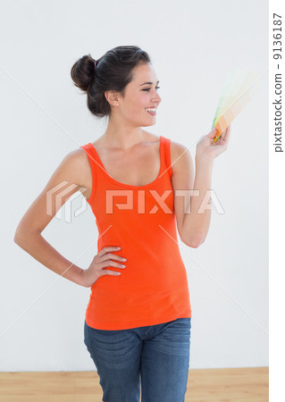 Woman choosing color for painting a room Woman choosing color for painting a room 9136187