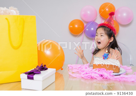 Cheerful surprised little girl at her birthday party Cheerful surprised little girl at her birthday party 9136430
