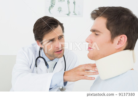 Doctor examining a patients sprained neck at office Doctor examining a patients sprained neck at office 9137380
