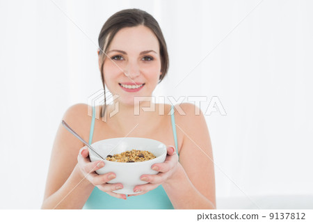 Close-up portrait of a young female with a bowl of cereal 9137812
