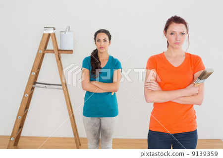 Friends with paint brushes and ladder in a new house Friends with paint brushes and ladder in a new house 9139359