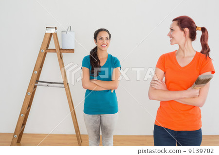 Friends with paint brushes and ladder in a new house Friends with paint brushes and ladder in a new house 9139702