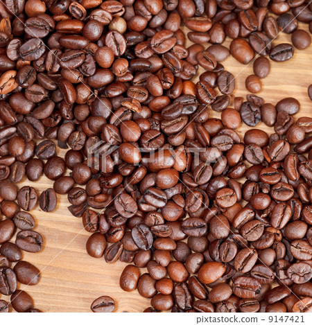 roasted coffee beans close up on wooden board roasted coffee beans close up on wooden board 9147421