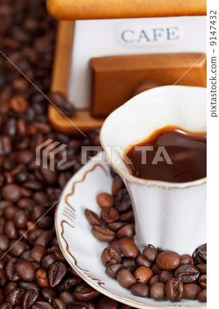 cup of coffee and roasted beans 9147432