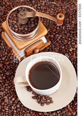 cup of coffee and roasted beans 9147600