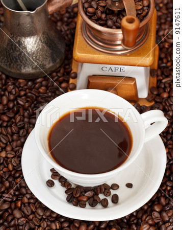 cup of coffee and roasted beans 9147611