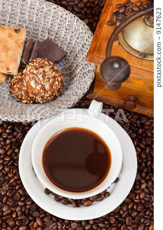 cup of coffee and roasted beans cup of coffee and roasted beans 9147623
