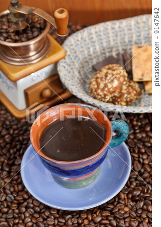 cup of coffee and roasted beans 9147642