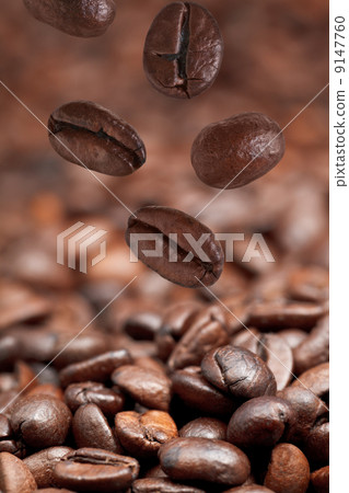 few falling beans and dark roasted coffee few falling beans and dark roasted coffee 9147760