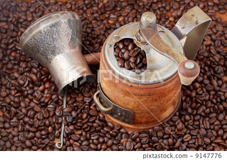 retro manual coffee mill on roasted beans retro manual coffee mill on roasted beans 9147776