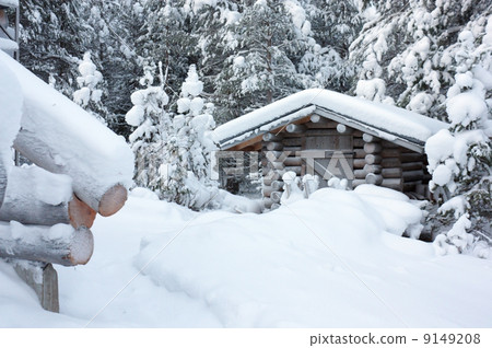 Small wooden blockhouse under white snow 9149208