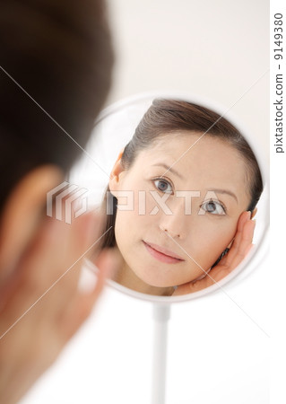 Woman looking in the mirror Woman looking in the mirror 9149380