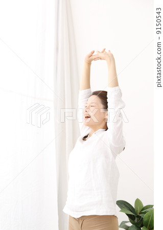 A woman basking in the morning sun 9150543
