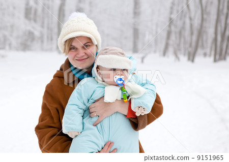 Mother and toddler boy having fun with snow on winter day 9151965