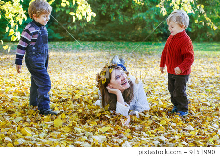 Happy mother with little son having fun in autumn park. Happy mother with little son having fun in autumn park. 9151990