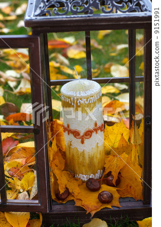 Antique lantern decorated with autumn leaves and candle 9151991