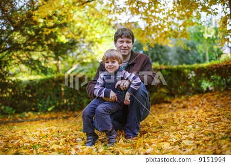Happy father with little son having fun in autumn park. Happy father with little son having fun in autumn park. 9151994