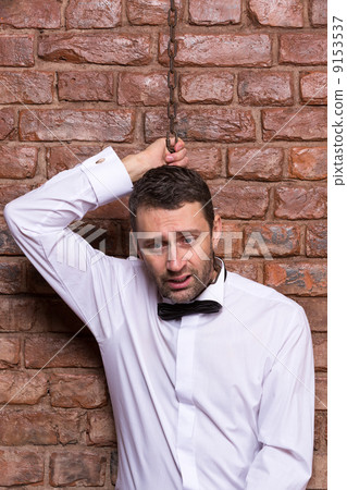 Desperate man with a chain around his neck 9153537