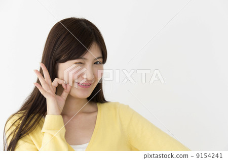 A woman who issues an OK sign A woman who issues an OK sign 9154241