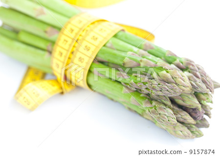 asparagus tied with measuring tape isolated on white asparagus tied with measuring tape isolated on white 9157874