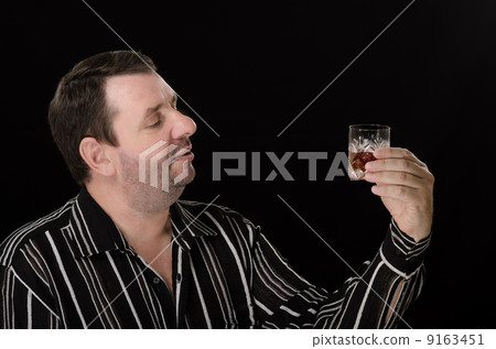 Unshaven man wants to drink brandy 9163451