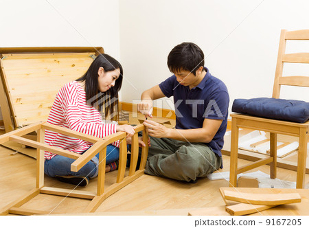 Asian couple assembling chair Asian couple assembling chair 9167205