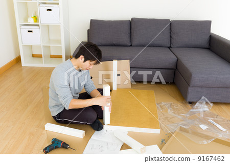Man assembling cupboard Man assembling cupboard 9167462