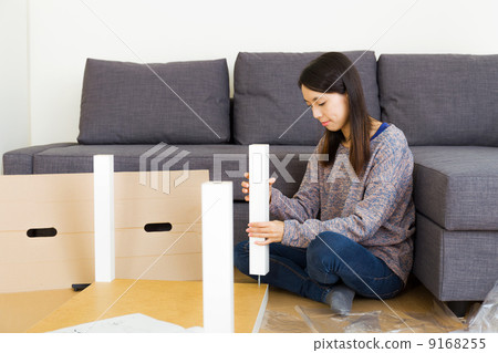 Asian woman assembling new furniture 9168255