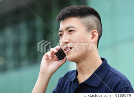 Young man talking on phone outdoors Young man talking on phone outdoors 9168979