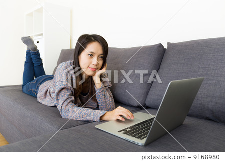 Asian woman using laptop at home Asian woman using laptop at home 9168980