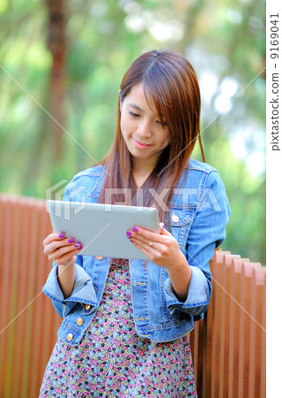 young asian woman with tablet pc 9169041