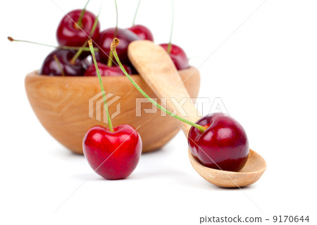 red cherry in wooden spoon and bowl, isolated on white backgroun 9170644