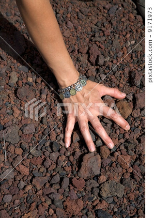 hand on volcanic stones hand on volcanic stones 9171973