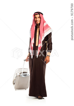 Young smiling arab with a suitcase isolated on white Young smiling arab with a suitcase isolated on white 9179780
