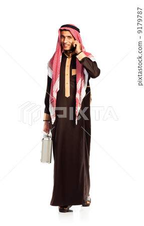 Young smiling arab with a aluminum case and cellphone isolated o Young smiling arab with a aluminum case and cellphone isolated o 9179787