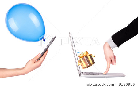 hand with a gift and laptop hand with a gift and laptop 9180996