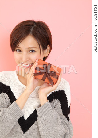 A woman giving a gift A woman giving a gift 9181851