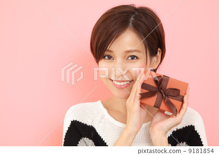 A woman giving a gift 9181854
