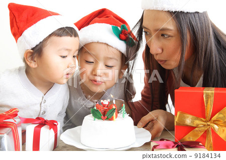 A family that blows out candles of Christmas cake candles 9184134