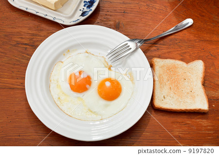 breakfast with two fried eggs in white plate breakfast with two fried eggs in white plate 9197820