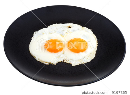 fried eggs on ceramic black plate fried eggs on ceramic black plate 9197865